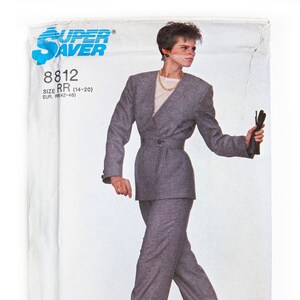 May include: A sewing pattern for a grey suit jacket and trousers. The pattern is for sizes 14-20 and is called "Super Saver" 8812.