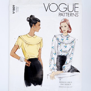 May include: A Vogue Patterns sewing envelope V1809 featuring two blouse designs. Design A is a short-sleeved yellow blouse with a collar. Design B is a long-sleeved white blouse with a blue and yellow floral pattern and a collar. Both are paired with black skirts.