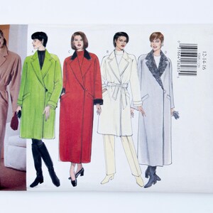 May include: A Butterick Classics sewing pattern envelope, number 5205, for a long coat in sizes 12-14-16. The front displays five illustrations of the coat in various colours including tan, lime green, red, white, and light grey with a faux fur collar.