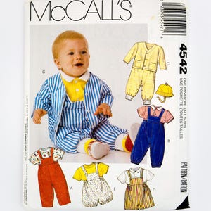 May include: McCall's pattern envelope showing a baby in striped pyjamas. The envelope displays various baby clothing designs, including dungarees and a yellow striped outfit. The number 4542 is visible on the right side.