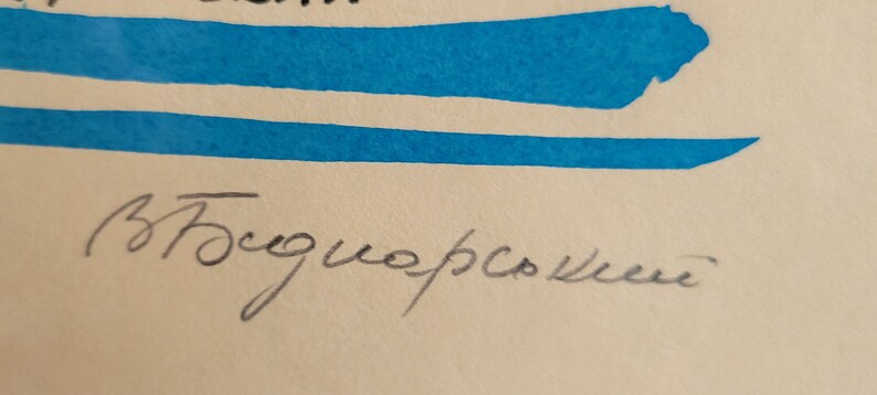 May include: Artwork with blue brushstrokes and handwritten text. The text appears to be a signature in black ink. The background is a light beige color.