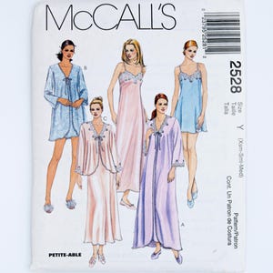 May include: McCall's sewing pattern 2528, size Y, featuring illustrations of sleepwear including robes and nightgowns with lace trim. The pattern envelope displays five variations of loungewear in blue, pink, and lavender colours with tie closures.