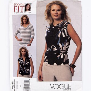 May include: Vogue Patterns sewing pattern V1085. The pattern features three different tops. One top is a cowl neck with a black and white floral print. The other top is a striped long sleeve shirt. The pattern includes the text "Today's Fit by Sandra Betzina."