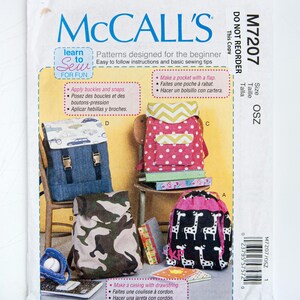 May include: McCall's sewing pattern for beginner backpack designs. The pattern features several backpack styles, including denim, camouflage, polka dot, and giraffe print options. Instructions include making pockets, applying buckles, and using drawstrings.
