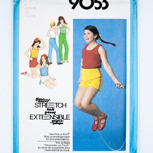 May include: Simplicity sewing pattern number 9053 for a girl's dress. The pattern is for sizes 7, 8, 10, 8, 10, 12, and 10, 12, 14. The pattern includes instructions for making a stretch knit dress. The pattern cover features a girl jumping rope wearing a red tank top and yellow skirt.