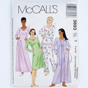 May include: A McCall's 3893 sewing pattern envelope featuring illustrations of four different loungewear garments. The designs include a long lavender gown, a knee-length light green dress, a floral print pyjama set, and a long lavender robe.