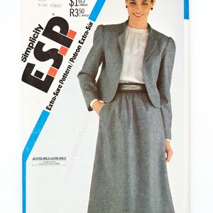 May include: Simplicity ESP sewing pattern 5693 featuring a woman in a gray skirt suit. The pattern includes sizes 0, 12, 14, and 16. The text "Extra-Sure Pattern" is visible. The blouse is not included.