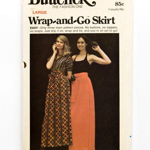 May include: Vintage Butterick sewing pattern for a Wrap-and-Go skirt. The pattern cover features two women modeling the skirt. The text on the cover reads "Wrap-and-Go Skirt" and includes size options from Petite (23) to Large (30-32).