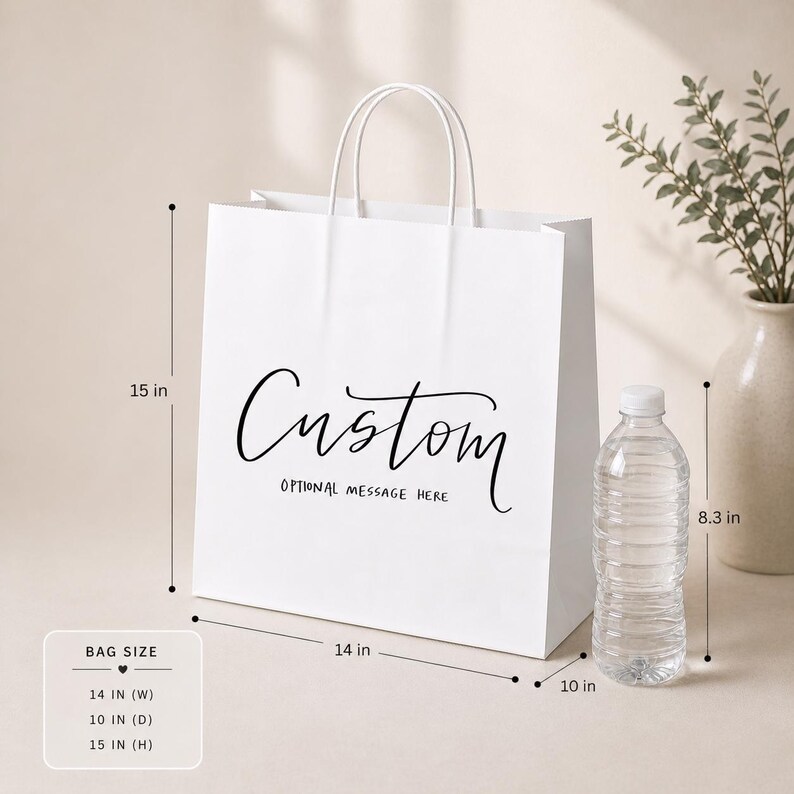 May include: A white paper shopping bag with a custom design, featuring the word "Custom" in elegant script. The bag is 14 inches wide, 10 inches deep, and 15 inches high, with white handles. The text "OPTIONAL MESSAGE HERE" is below the word "Custom".