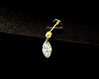 May include: A gold-colored nose stud with a marquise-cut, clear gemstone. The stud features a curved post and a small, round accent. The text "STAR JEWELLERY" is visible.