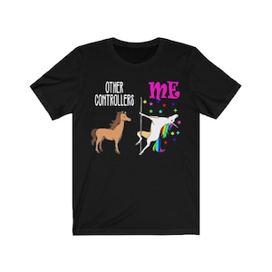 May include: Black t-shirt with a humorous graphic. The design features a brown horse and a unicorn pole dancing. Text reads "OTHER CONTROLLERS" and "ME" in pink.