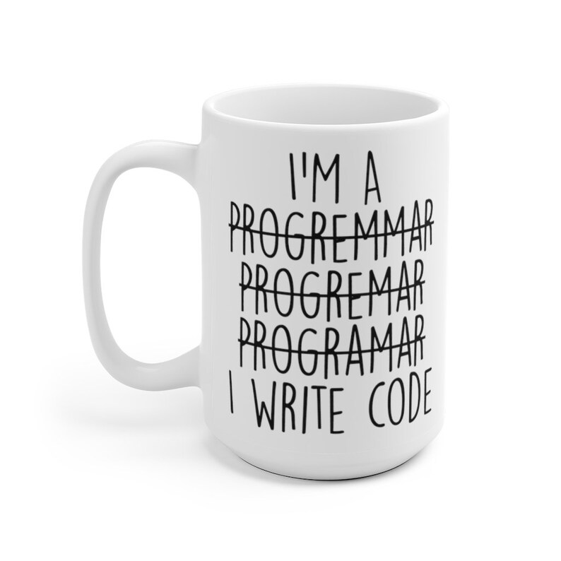 May include: White ceramic mug with a large handle. The mug features the text "I'M A PROGREMMAR PROGREMMAR PROGARAMAR I WRITE CODE" in black, with the word "PROGREMMAR" crossed out multiple times. A humorous gift.
