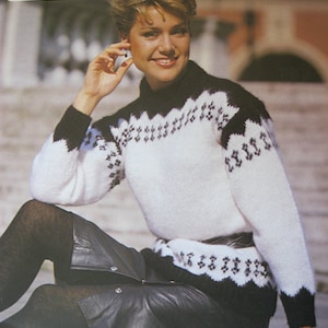 May include: A woman wearing a white and black patterned sweater with a black leather skirt. The sweater has a high neck and a geometric design. The text "KAFTAN" and "Lister-Lee" are visible in the upper left corner. Bust sizes are listed as 32/34; 36/38 inches.