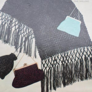 May include: A black crocheted shawl with fringe and two small purses. One purse is turquoise blue and the other is a dark burgundy color.