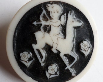 Vintage plastic Artid button - Cupid on horseback on black background  1.1/4" dia - made in England