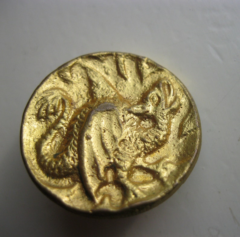 Antique brass button featuring dragon has brass loop shank and measures 1.18 dia