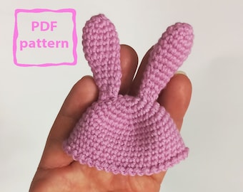 May include: A pink crocheted bunny hat with long ears. PDF pattern included.