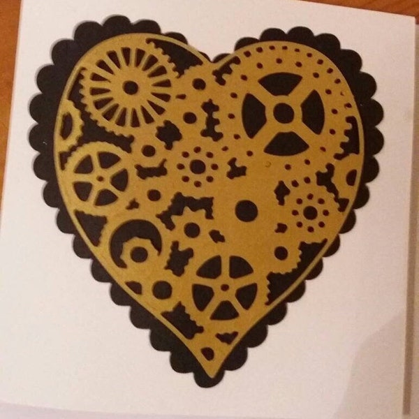 Handmade steampunk heart card. 6 x 6 .Unusual bespoke black and gold featuring interlocking cogs and wheels in the shape of a heart.