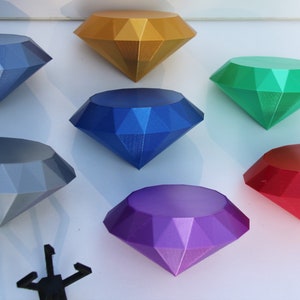 May include: Seven colorful diamond-shaped gems in various colors including gold, blue, green, gray, purple, and red.