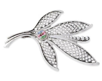 May include: Silver filigree brooch with a colorful, iridescent stone in the center. The brooch is shaped like a stylized flower with three leaves.