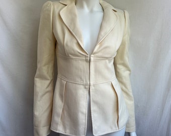 May include: A cream-colored blazer with a fitted waist and a deep V-neck. The blazer has long sleeves and a single-breasted closure.