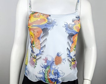 May include: White mesh tank top with a colorful Japanese-inspired print featuring a dragon, waves, and flowers.