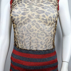 May include: A sleeveless, sheer, leopard print top with a red and gray striped knit bottom.