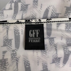 May include: A black and white label with the text "GFF GIANFRANCO FERRE" on a white background with a black and white pattern.