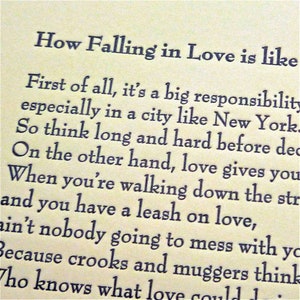 May include: Close-up of a page with black text on a cream-colored background. The title reads "How Falling in Love is like." The text continues with a description of love's responsibilities, especially in a city like New York.