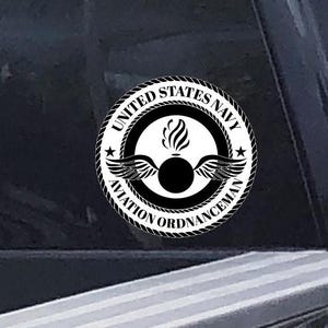 May include: Black and white sticker with the text "United States Navy Aviation Ordnanceman" in a circle with a bomb and wings inside.