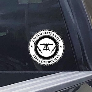 May include: A black and white sticker with the text "United States Navy Fire Controlman" and a symbol of a fire control system.