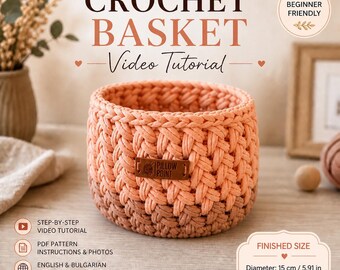 Op de afbeelding: Een perzikroze gehaakte mand met een geweven textuur. De mand heeft een leren label met de tekst "PILLOW POINT". De tekst "CROCHET BASKET Video Tutorial" staat boven de mand. De diameter is 15 cm.
