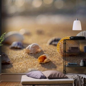 May include: A beach scene with seashells scattered on golden sand. The image features a close-up of several seashells, with a blurred background of the ocean and sunlight. The scene evokes a sense of tranquility and natural beauty.