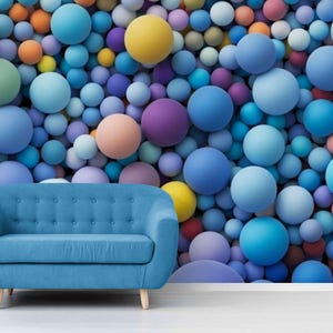 May include: A blue sofa with wooden legs sits in front of a wall covered in colorful spheres. The spheres are in shades of blue, purple, orange, yellow, and pink, creating a vibrant and playful backdrop.