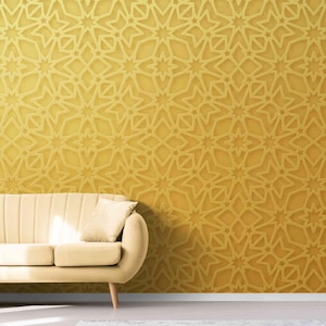 Puede incluir: Un sofá beige con patas de madera y dos cojines se encuentra frente a una pared con un patrón de estrellas repetido. La pared es de color amarillo cálido, y el patrón es de un tono más claro. Una manta color crema está sobre el sofá.