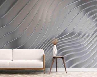 May include: A white sofa with wooden legs sits in front of a wall with a silver, wavy, abstract pattern.