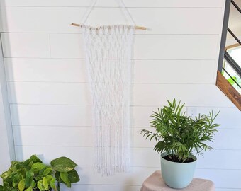 White macrame on natural wooden stick