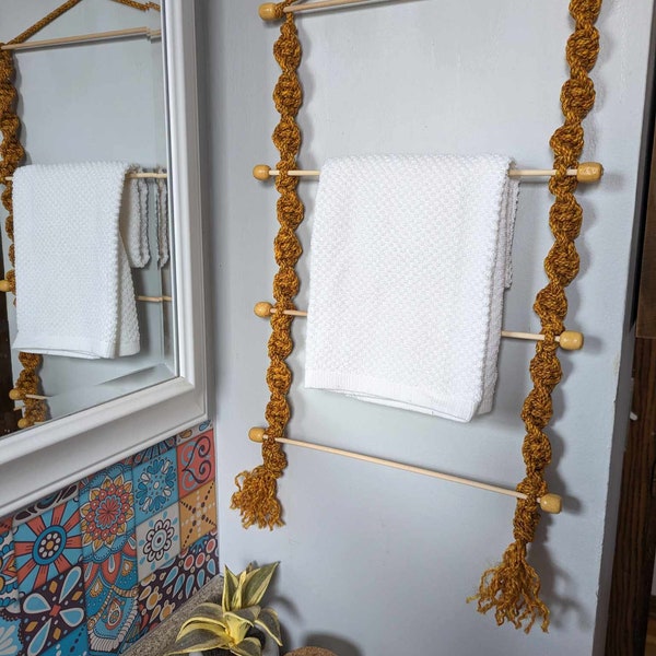 Orange speckled macrame towel rack with natural colored beads.