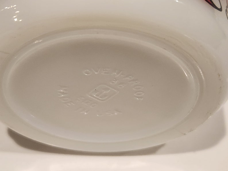 May include: White, oven-proof dish with a rounded base. The bottom of the dish is light gray and features the text "OVEN-PROOF", "38", and "MADE IN U.S.A.". The dish has a simple, classic design.