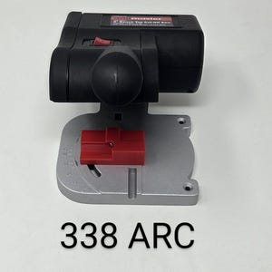 May include: Black and silver bench top cut-off saw with a red switch and a red adjustable guide. The saw has the text "Master" on it. The text "338 ARC" is below the saw.