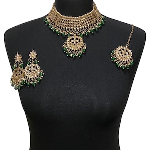 Gold green coloured Pakistani bridal necklace jewellery set including elegant Asian engagement necklace, indian wedding tikka and earrings