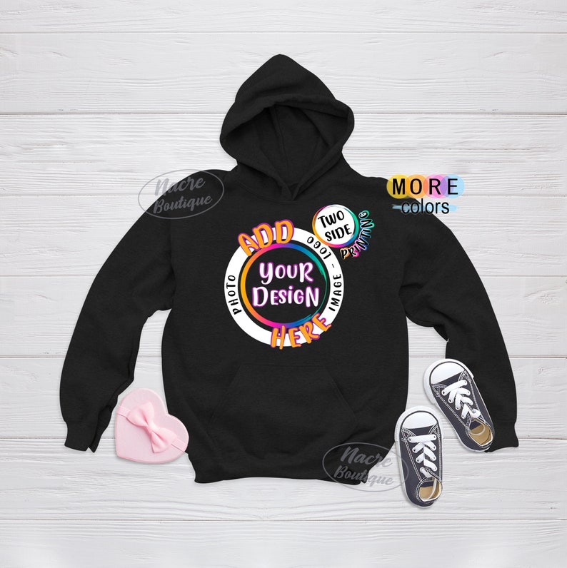 May include: Black hooded sweatshirt with a white circle design that says "Add Your Design Here" in rainbow colours. The circle also has the text "Two Side Printing" and "Photo - Image" in smaller text. The sweatshirt is on a white wooden background.