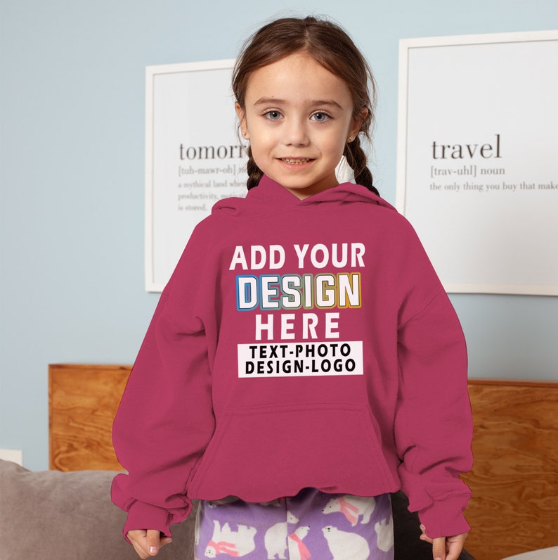 May include: A pink hooded sweatshirt with the text "ADD YOUR DESIGN HERE TEXT-PHOTO DESIGN-LOGO" in colourful letters.