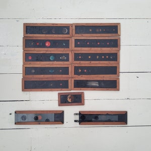May include: A set of 11 vintage wooden framed glass slides depicting the solar system. The slides are numbered and labeled with handwritten text. The slides are arranged in two rows on a white surface.