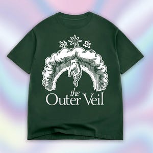 May include: A dark forest green short-sleeve t-shirt featuring a white graphic print of a hand reaching down from a cloud archway with three stars above it. The text "the Outer Veil" is printed in white lettering below the graphic illustration.