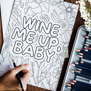 May include: A black and white coloring page with a floral design and the text "Wine Me Up, Baby".