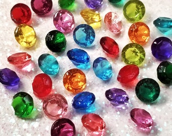 May include: Assortment of colourful diamond-shaped cake toppers made of sugar. The toppers are in various colours, including red, blue, green, yellow, purple, and orange. ISOMALTCRYSTALJEWELS ETSYSHOP: COLOURFUL DIAMOND CAKE TOPPER