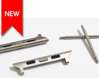 May include: Two silver watch band connectors and two silver watch band spring bars. The connectors have a silver finish and three black accents. The spring bars are straight and have a silver finish.