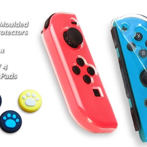 May include: Two clear plastic cases for Nintendo Switch Joy-Con controllers, one pink and one blue. A set of four paw-shaped joystick thumb grips in pink, yellow, white, and blue.