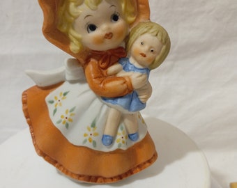 Vintage Porcelain Girl Holding Her Doll
